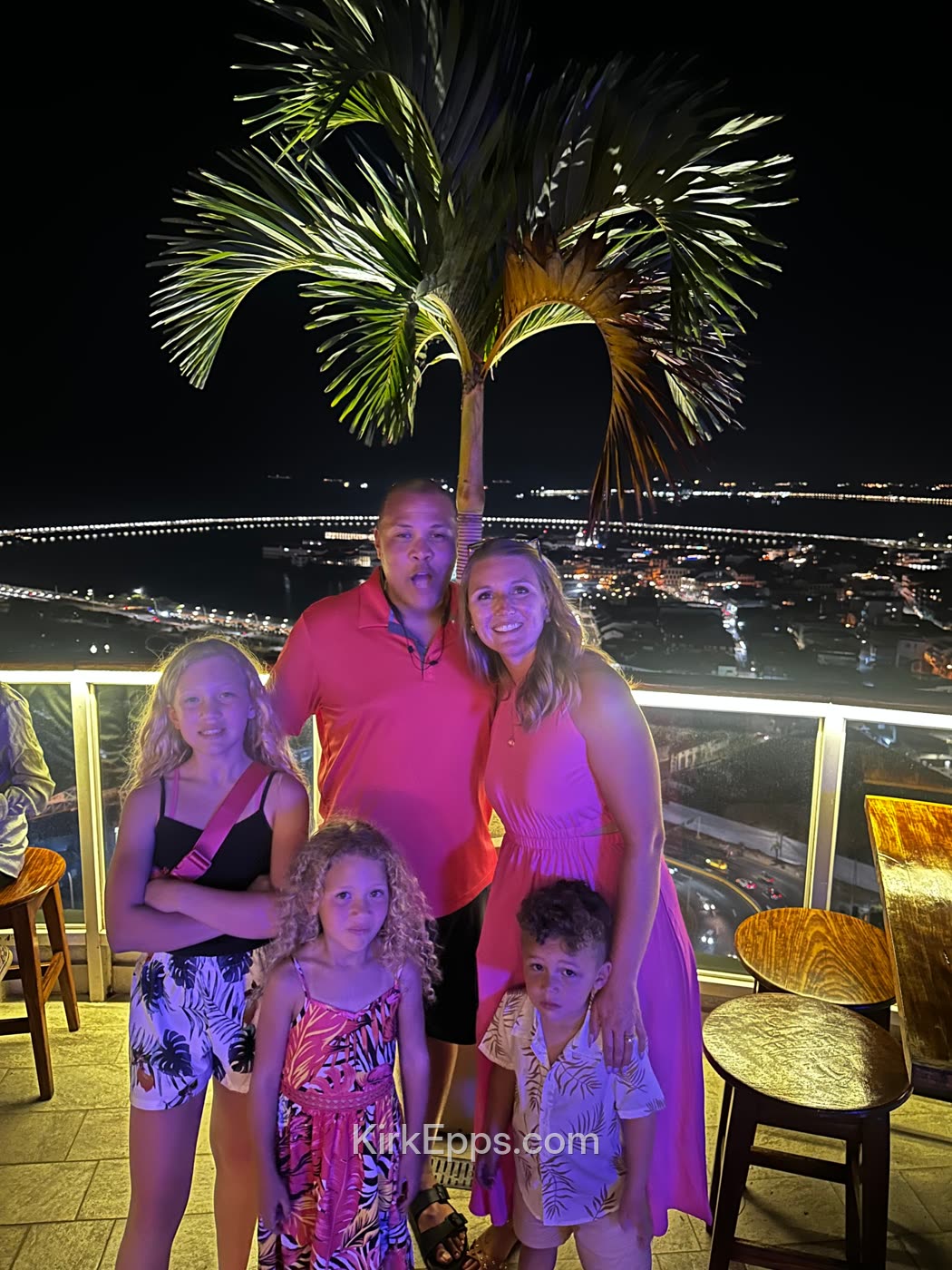 The Epps family on a rooftop at night during a family trip