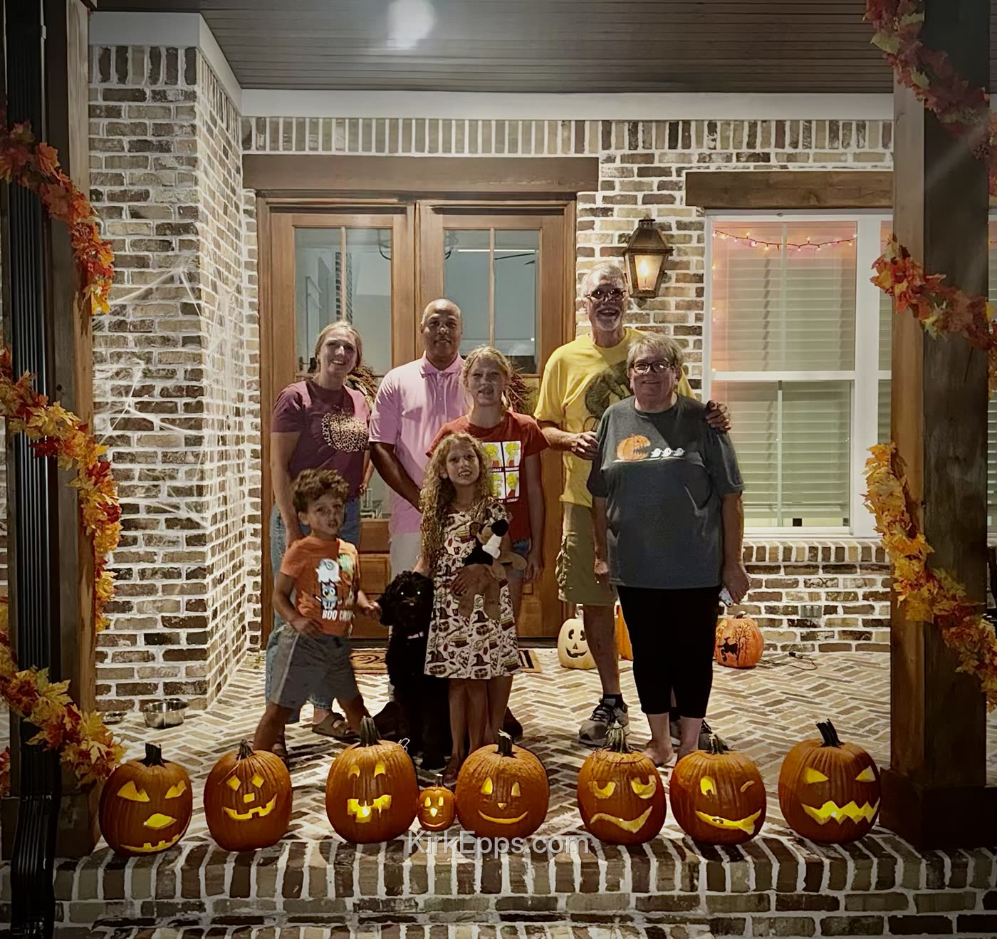 Kirk's family and grandparents with their carved pumpkins at Halloween